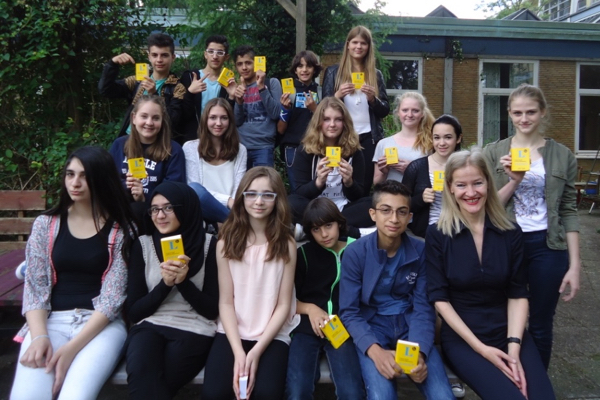 LMAC twins giving dictionaries to the refugee pupils